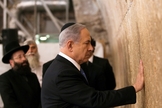 O primeiro-ministro de Israel, Benjamin Netanyahu, toca as pedras do Muro das Lamentações, o lugar do judaísmo mais sagrado para a oração, na Cidade Velha de Jerusalém.
