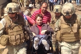 Pastor Rúben sendo carregado por militares. 