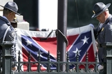 Guardas retiram bandeira confederada dos jardins do Capitólio. (AP Photo/John Bazemore)