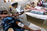Imagem ilustrativa. Enfermeira cuida de homem enfermo em hospital, na Índia. (Foto: Reprodução)