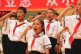 'Jovens Pioneiros' em uma escola primária na região autônoma de Ningxia Hui fazem um juramento durante uma atividade do evento "O Lenço Vermelho Segue a Festa" no Dia das Crianças. (Foto: Bitter Winter)