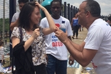 Pastor Dejota Júnior distribui água e canetas para estudantes, em Goiânia. (Foto: G1/Murillo Velasco)