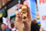 Manifestante segura modelo de um embrião de 12 semanas em uma manifestação contra o aborto em Belfast. (Foto: Reprodução/Reuters)