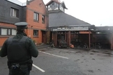 Policial observa igreja incendiada na Irlanda do Norte. (Foto: Reprodução / Bíblia Todo)