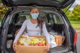 Diana Vergara possui uma caixa de alimentos frescos doada a sua família pela Visão Mundial na Igreja Adventista de Auburn City em Auburn, Washington. (Foto: Visão Mundial / Laura Reinhardt).
