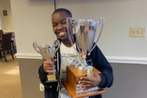 Tanitoluwa Adewumi, de 10 anos, é o mais novo mestre nacional de xadrez dos EUA. (Foto: Reprodução/Facebook).