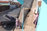 A idosa varria a calçada de casa quando uma caminhonete desgovernada quase a atingiu. (Foto: Reprodução/G1).