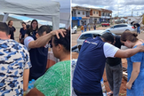 Moradores recebem oração em tenda montada por igreja em Rio Bonito do Iguaçu. (Foto: Universal)
