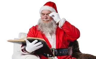 Papai Noel consultando a Bíblia. (Foto: Canva)