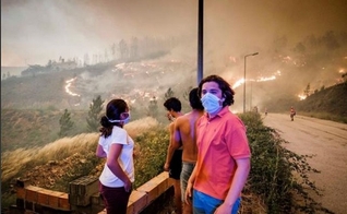 Pessoas assistem de longe às chamas se espalhando pela mata, na região de Pedrógão Grande. (Foto: Global Imagens)