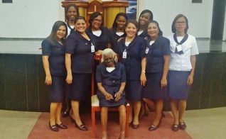 Dona Maria continua vestindo seu uniforme de obreira, aos 104 anos. (Foto: Reprodução)