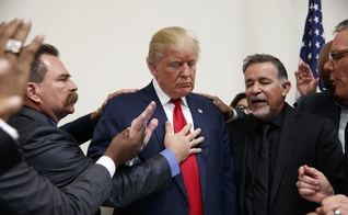 Pastores oram por Donald Trump durante visita à Igreja Internacional de Las Vegas e à Academia Cristã Internacional. (Foto: Evan Vucci / AP)