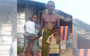 Khanjana ao lado da esposa e dois filhos, em frente à cabana da família. (Foto: Gospel For Asia)