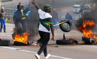 Defensores do ex-presidente sul-africano Jacob Zuma bloqueiam estradas com pneus em chamas. (Foto: Reprodução / BBC)
