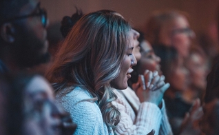 Estudante durante culto de adoração. (Foto: Reprodução/Twitter/Regent University)