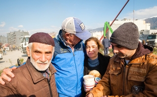 Família afetada pelo terremoto com missionários locais. (Foto: Ilustração/Send Relief)