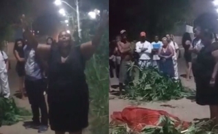 A mãe com o corpo do filho em rua no RJ. (Foto: Reprodução/Portal Tucumã)