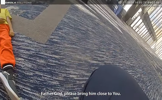 Policial ora ao encontrar criança caída e baleada. (Captura de tela/YouTube/ HPD Critical Incident)