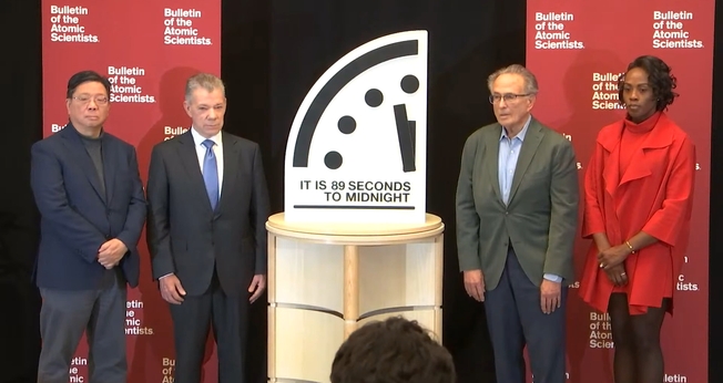 Cientistas ao lado do Relógio do Juízo Final, marcando 89 segundos para a meia-noite. (Captura de tela/YouTube/Bulletin of the Atomic Scientists)