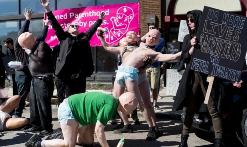 O protesto foi realizado por satanistas que se vestiram de "bebês sadomasoquistas". (Imagem: Youtube)