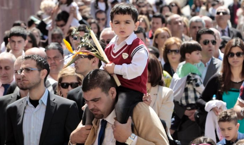 Cristãos libaneses carregam caminham no Domingo de Ramos, em Beirute. (Foto: Hussein Malla/AP)