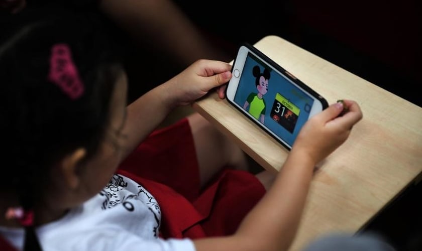 Criança assiste vídeo qualquer do Youtube em smartphone. (Foto: The Straits Times)