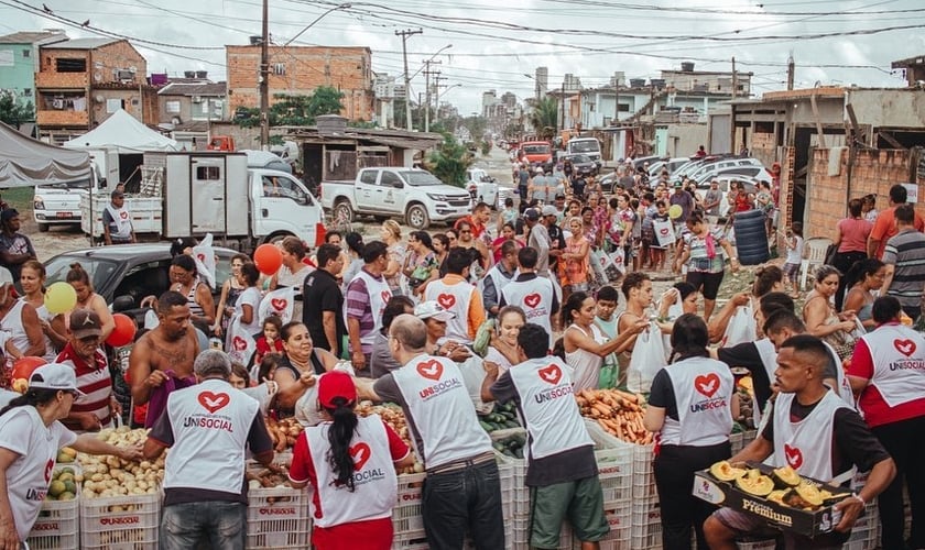 Voluntários distribuem alimentos para pessoas que perderam renda na periferia de São Paulo. (Foto: Unisocial)