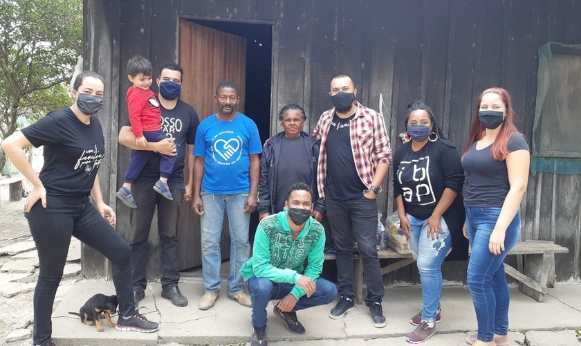 Pastor Samuel Santos (blusa xadrez) e outros voluntários visitam famílias ribeirinhas necessitadas para entregar alimentos e materiais para reconstruir as casas. (Foto: Arquivo Pessoal)