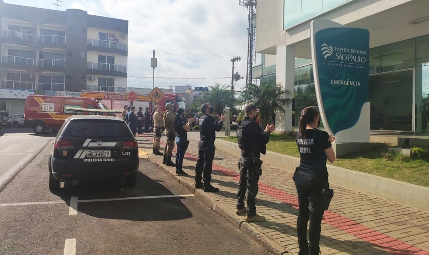 Policiais civis e militares e bombeiros fizeram uma oração em frente ao Hospital Regional São Paulo. (Foto: Alessandra Bagattini/Lance Notícias)