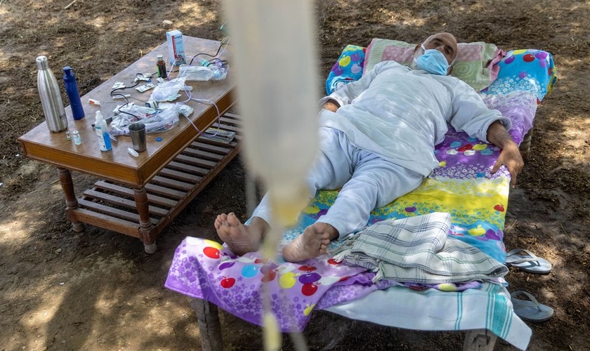Um paciente Covid-19 recebe tratamento em uma clínica improvisada ao ar livre na vila de Mewla, Uttar Pradesh. (Foto: Reprodução / Reuters)