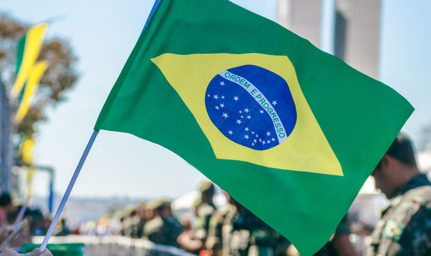 Bandeira do Brasil é erguida durante manifestação popular. (Foto: Pexels)