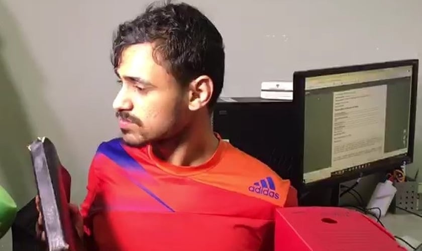 José Diego dos Santos segura Bíblia enquanto fala aos jornalistas que quer deixar a criminalidade. (Foto: Reprodução/TV Paraíba)