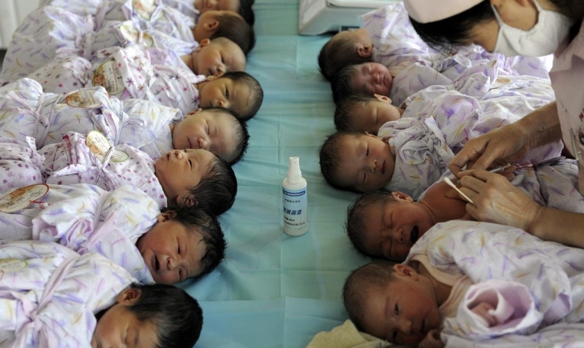 Bebês são cuidados por enfermeira na China. (Foto: South China Morning Post)