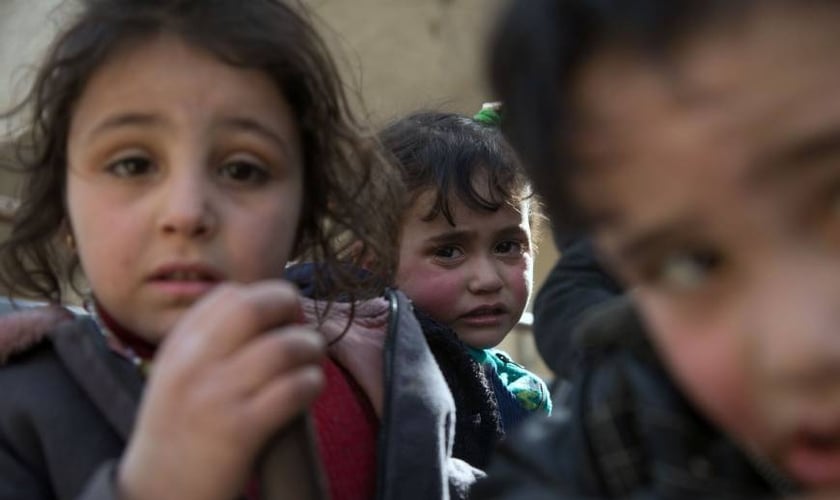 Crianças sírias fugindo de suas casas na região de Ghouta após ataques aéreos. (Foto: Abdulmonam Eassa/AFP)