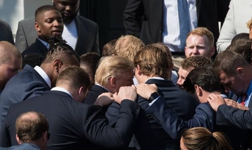 JK Scott e seus amigos se unem em volta do presidente dos EUA, Donald Trump para orar. (Foto: editiononline)