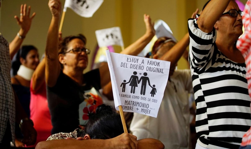 Cristãos cubanos acenam bandeiras com a frase: "Sou a favor do desenho original. A família como Deus a criou. Casamento entre homem e mulher”. (Foto: Reuters/Alexandre Meneghini)