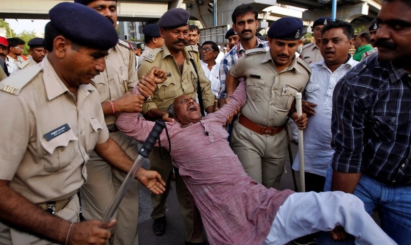 Membro da casta dos dalits continua protestando, enquanto é detido pela polícia indiana, na cidade de Ahmedabad, em abril de 2014 (Foto: Reuters)