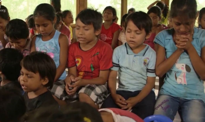 Crianças oram na 'aldeia infantil', construída sob liderança de María Scheelje. (Foto: CBN)