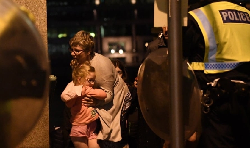 Mulher acolhe garotinha em meio à tensão do recente ataque terrorista, próximo à Ponte de Londres. (Foto:NBC)