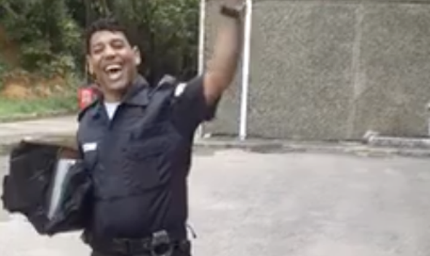 Usando a farda policial, o homem canta trechos do “Corinhos de Fogo”, de Andréa Fontes. (Foto: Reprodução/Facebook)
