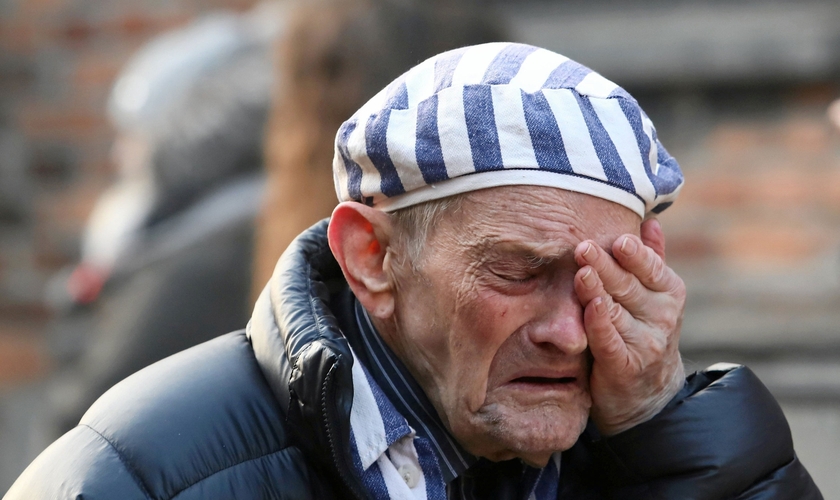 Sobrevivente chora no campo de concentração de Auschwitz, na Polônia, nesta segunda-feira (27), durante cerimônia que lembra os 75 anos da libertação. (Foto: Jakub Porzycki/Agência Gazeta via Reuters)