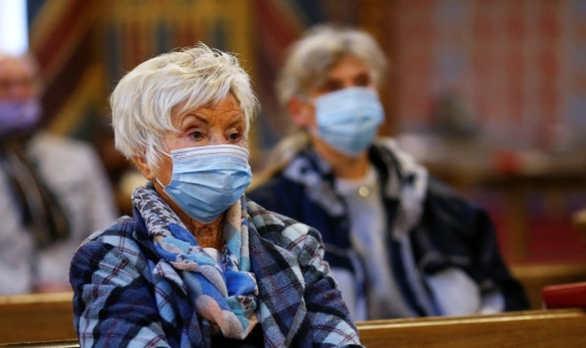Fiéis usam máscaras de proteção em igreja em Kevelaer, na Alemanha. (Foto: Reuters)