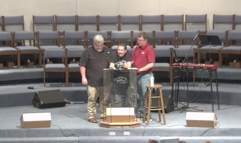 Pastor Matt Olson é amparado durante a maratona de pregação da Bíblia. (Captura de tela/Primeira Igreja Batista de Sharon)